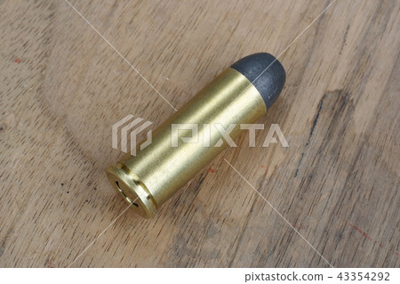 Revolver cartridges Wild West period on wood plate 43354292