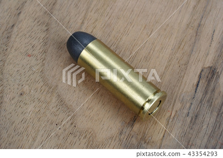 Revolver cartridges Wild West period on wood plate Revolver cartridges Wild West period on wood plate 43354293