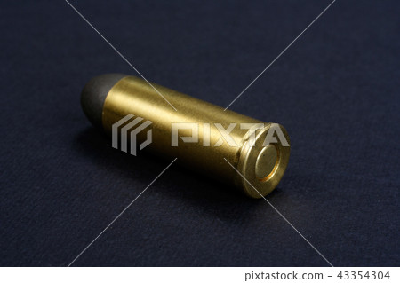Wild West Revolver cartridges on black background 43354304