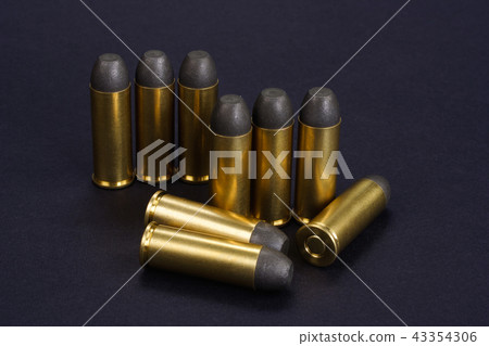 Wild West Revolver cartridges on black background 43354306