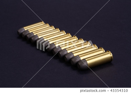 Wild West Revolver cartridges on black background Wild West Revolver cartridges on black background 43354310