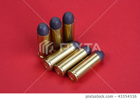 Wild West Revolver cartridges on red background 43354316