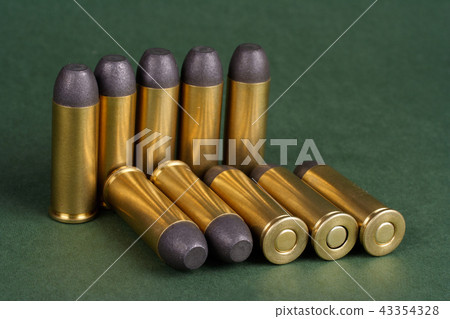 Wild West Revolver cartridges on green background 43354328