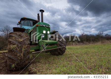 Tractor plowing fields. Tractor plowing fields. 43355211