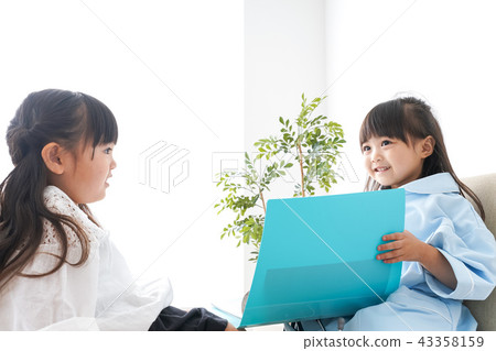 Child playing a doctor 43358159