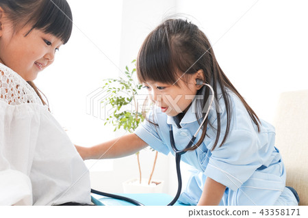 Child playing a doctor 43358171