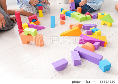 Child and teacher playing with blocks Child and teacher playing with blocks 43358539