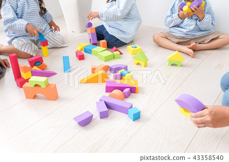 Child and teacher playing with blocks Child and teacher playing with blocks 43358540