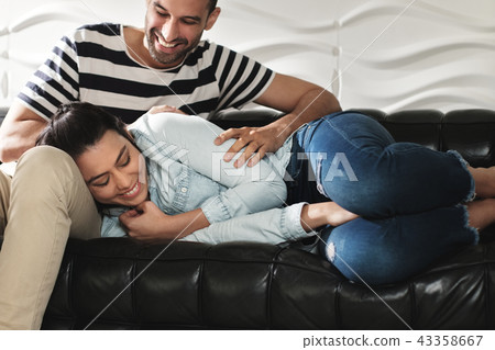 Happy Latino Couple Having Fun And Laughing On Sofa 43358667