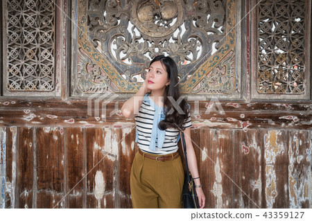 asian woman standing in Longshan Temple. asian woman standing in Longshan Temple. 43359127