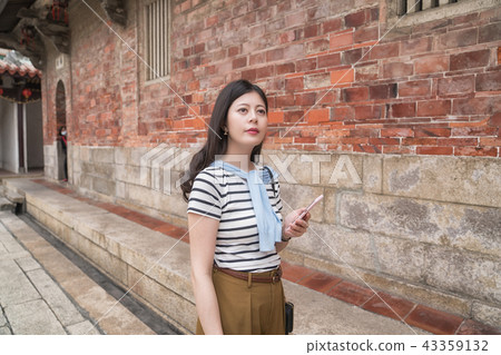 asian woman searching something by the mobile. 43359132