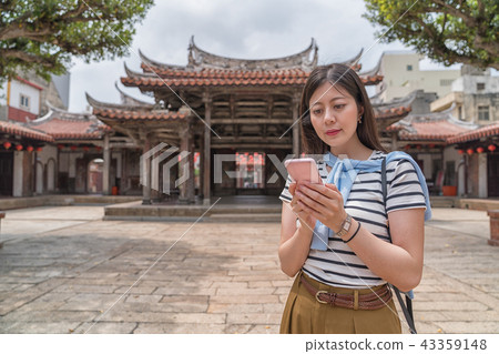elegant asian woman searching by the phone elegant asian woman searching by the phone 43359148