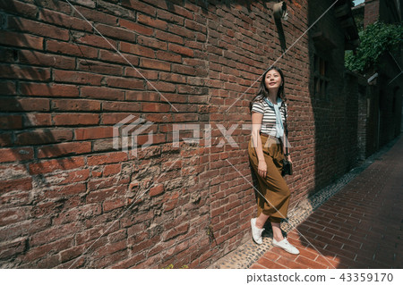 beautiful woman leaning on the wall. beautiful woman leaning on the wall. 43359170
