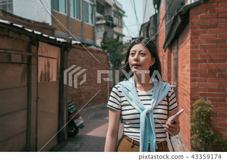 asian visitor strolling in the old street. asian visitor strolling in the old street. 43359174