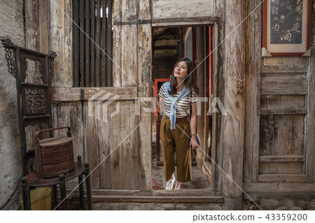 woman visiting the old chinese house. woman visiting the old chinese house. 43359200