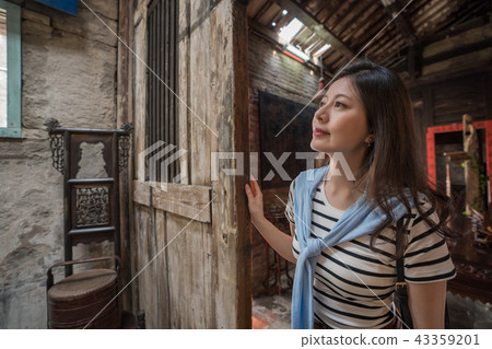 pretty woman visiting the old chinese house. 43359201
