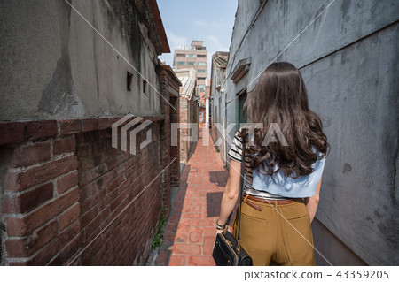 asian woman standing in the narrow alley. asian woman standing in the narrow alley. 43359205