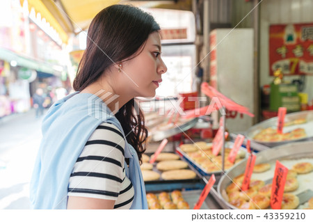 asian visitor looking for food in the market. 43359210