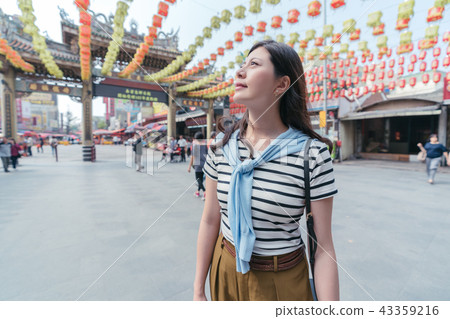 asian woman smiling and looking upward. asian woman smiling and looking upward. 43359216