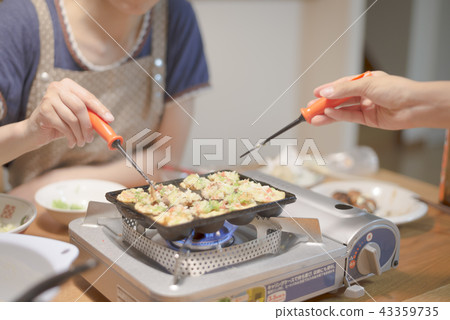 Mother and daughter making takoyaki Mother and daughter making takoyaki 43359735