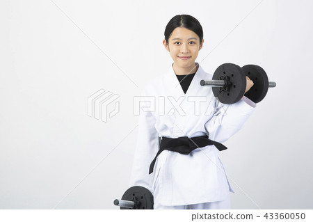 Female karateka who trains with dumbbells Female karateka who trains with dumbbells 43360050