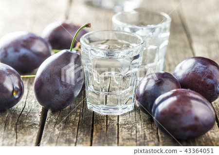 Plum brandy and plums. 43364051