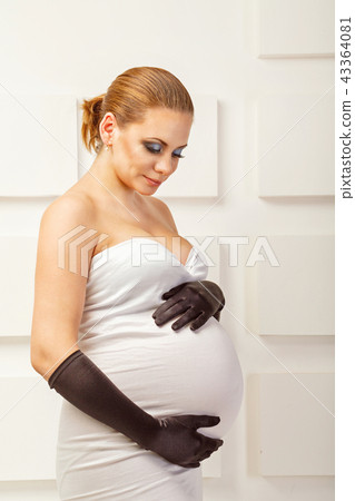 Young pregnant woman in fashionable dress 43364081