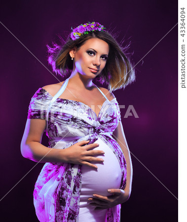 Young pregnant woman in fashionable dress 43364094