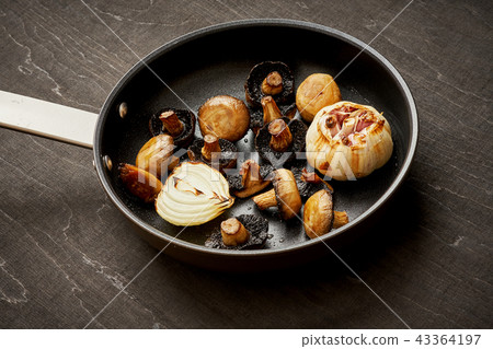 fried mushrooms on a hot pan on an old wooden table fried mushrooms on a hot pan on an old wooden table 43364197