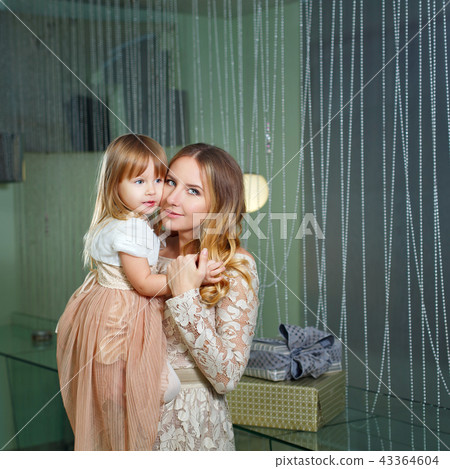 Mother and daughter hugging Mother and daughter hugging 43364604