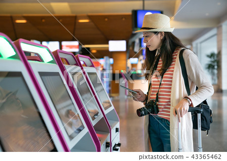 visitor confirming flights at the airport. 43365462
