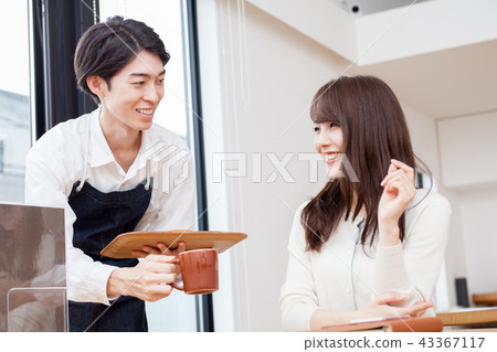A man working at a cafe A man working at a cafe 43367117