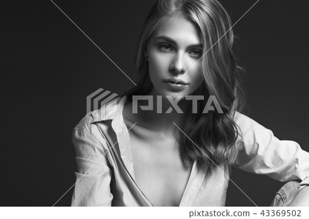 fashion model with long hair, perfect skin is posing in studio for glamour test photo shoot showing 43369502