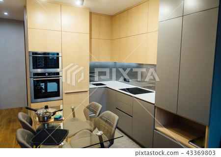 Modern kitchen with wooden furniture and wooden floor Modern kitchen with wooden furniture and wooden floor 43369803