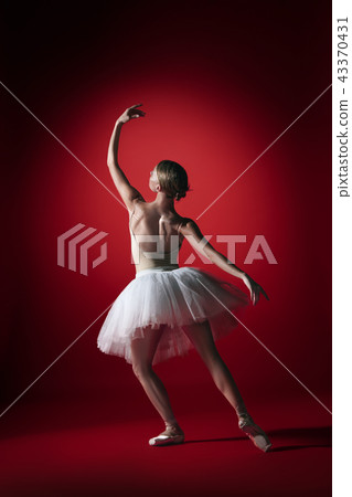 Ballerina. Young graceful female ballet dancer dancing at red studioskill. Beauty of classic ballet. Ballerina. Young graceful female ballet dancer dancing at red studioskill. Beauty of classic ballet. 43370431