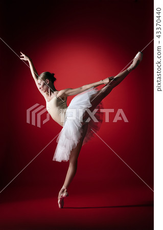 Ballerina. Young graceful female ballet dancer dancing at red studioskill. Beauty of classic ballet. Ballerina. Young graceful female ballet dancer dancing at red studioskill. Beauty of classic ballet. 43370440