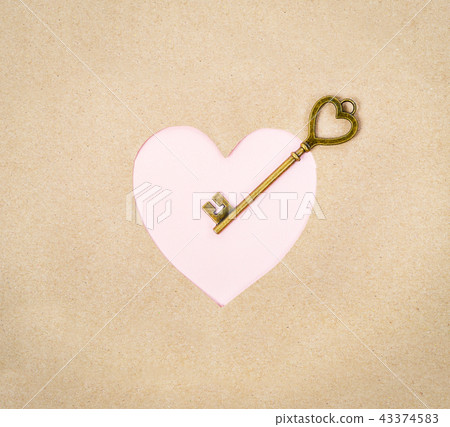 Old key vintage on pink heart paper. Old key vintage on pink heart paper. 43374583