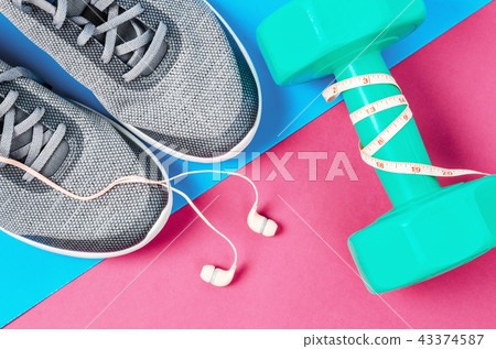 Green dumbbell and sneakers. Green dumbbell and sneakers. 43374587