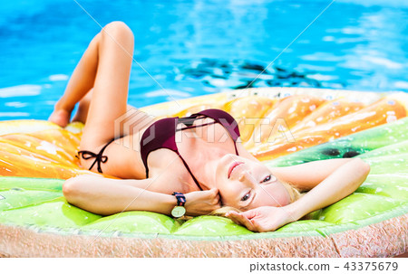 Beautiful model girl lies on shapes air mat 43375679