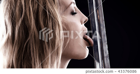 sexy warrior viking girl licks the blade of sword 43376086