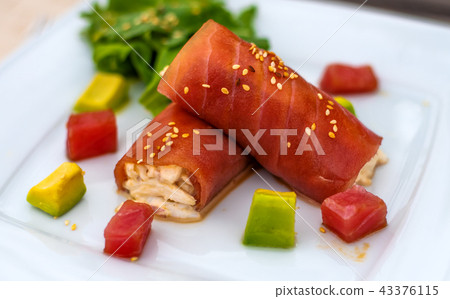 rolls of tuna with crab meat on the plate 43376115