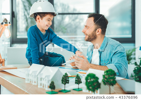 Pleased kid spending time with his father Pleased kid spending time with his father 43376896