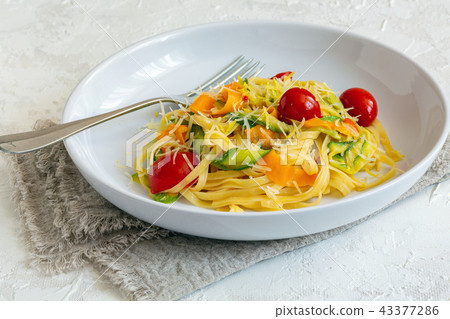Homemade pasta with strips of zucchini and carrots 43377286