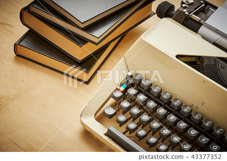 bright old typewriter with gray keys and books bright old typewriter with gray keys and books 43377352