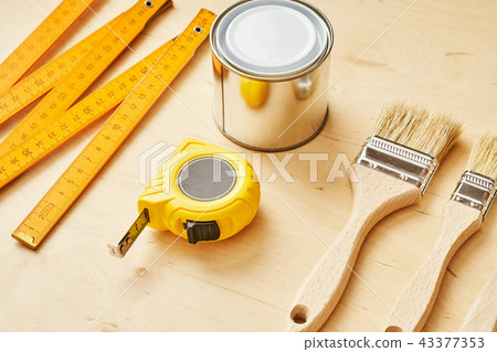 background with a ruler, tape measure, brushes and paint can background with a ruler, tape measure, brushes and paint can 43377353