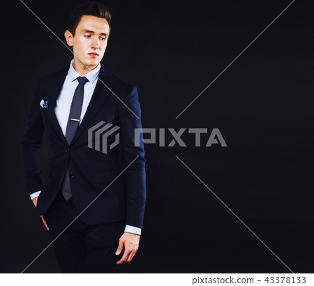 young pretty business man standing on black background, modern h 43378133