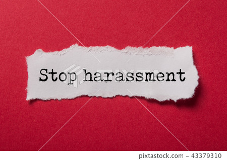 white torn paper  with text - Stop harassment 43379310