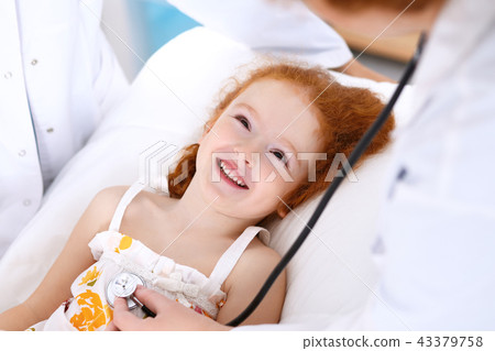 Doctor examining a little girl with stethoscope.Medicine and healthcare concept Doctor examining a little girl with stethoscope.Medicine and healthcare concept 43379758