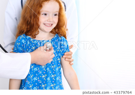 Doctor examining a little girl with stethoscope.Medicine and healthcare concept Doctor examining a little girl with stethoscope.Medicine and healthcare concept 43379764