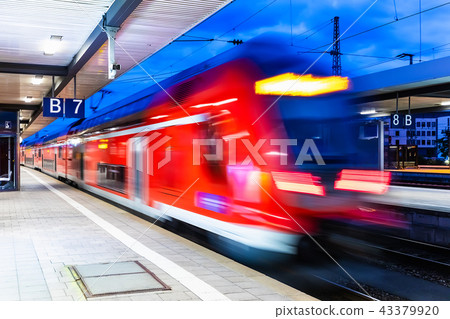 High speed train at railway station platform at night 43379920